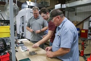 Three Mitotech employees working at a table